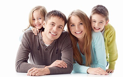 Smiling family against a white background