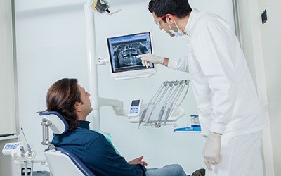 Dentist showing male patient his dental x-rays