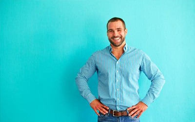 Man in front of blue background 