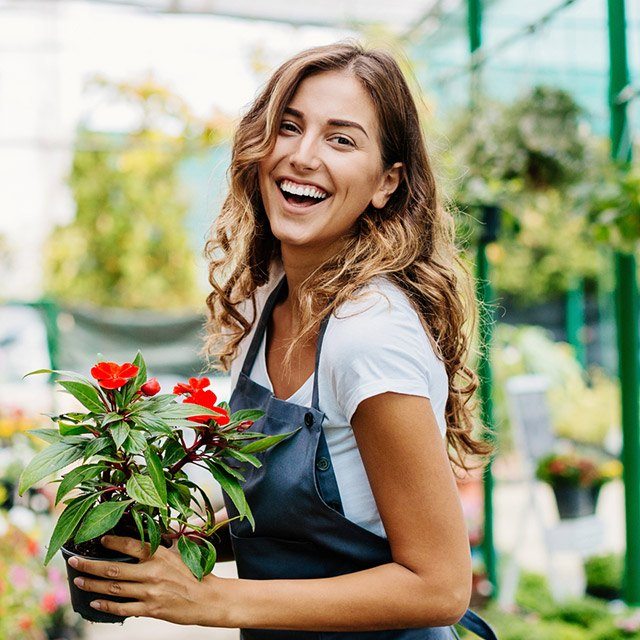 Laughing woman in green house