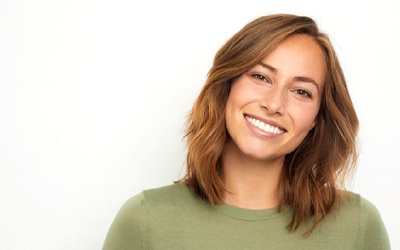 A woman smiling in front of a white background
